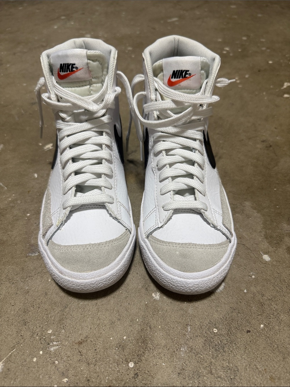 Nike White High-Top Sneakers with Black Swoosh and Orange Tongue Logo